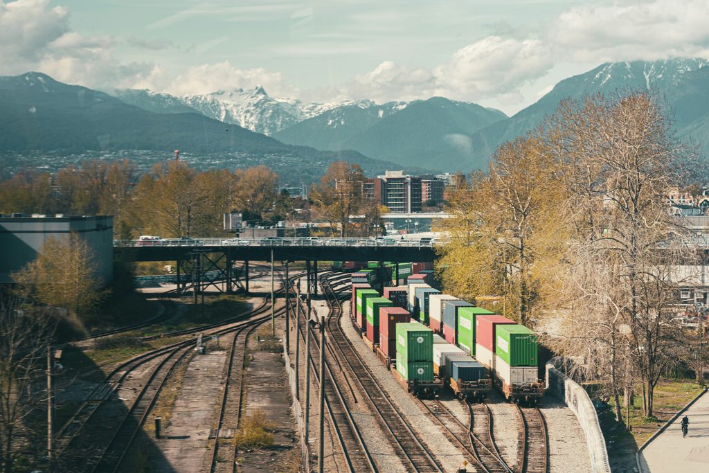 Freight train carrying containers, highlighting integrated transport across multimodal networks.