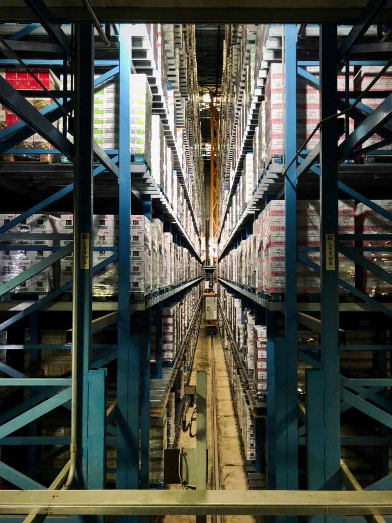 Secure bonded warehouse aisle with numbered pallets demonstrating fully transparent storage facilities.